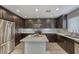 Modern kitchen featuring espresso cabinets, stainless appliances, speckled counters and backsplash, and large island at 815 E Rose Ln # 105, Phoenix, AZ 85014