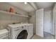 Functional laundry room with washer, dryer, and ample storage space at 815 E Rose Ln # 105, Phoenix, AZ 85014