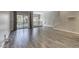 Open living room with wood-look tile flooring, balcony and large windows for natural light at 815 E Rose Ln # 105, Phoenix, AZ 85014