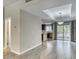 Open-concept living room featuring hard surface floors, neutral walls, and lots of natural light from the large sliding door at 815 E Rose Ln # 105, Phoenix, AZ 85014