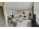 Bright living room features modern furnishings, neutral tones, and an open concept layout to the dining area at 815 E Rose Ln # 105, Phoenix, AZ 85014