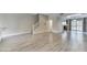 Open-concept living room with wood-look tile flooring and abundant natural light at 815 E Rose Ln # 105, Phoenix, AZ 85014