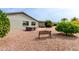Scenic backyard featuring desert landscaping, hot tub, patio area, and lush greenery for private outdoor living at 8229 E Farmdale Dr, Mesa, AZ 85208