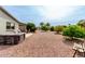 Tranquil backyard with desert landscaping, hot tub, and comfortable seating, offering relaxing outdoor retreat at 8229 E Farmdale Dr, Mesa, AZ 85208