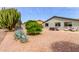 Large backyard showcases desert landscaping, a hot tub, and beautiful trees, creating serene outdoor space at 8229 E Farmdale Dr, Mesa, AZ 85208