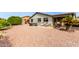 Expansive backyard featuring desert landscaping, hot tub, lounge chairs, and patio area, creating private retreat at 8229 E Farmdale Dr, Mesa, AZ 85208