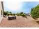 Backyard showcases desert landscaping, hot tub, and mature trees, creating serene and private outdoor oasis at 8229 E Farmdale Dr, Mesa, AZ 85208