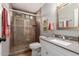 Bathroom featuring tile floors, gray walls, glass-enclosed shower, and a white vanity with a mirror at 8229 E Farmdale Dr, Mesa, AZ 85208