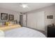 Comfortable bedroom featuring two beds, neutral-colored walls, and a large closet with sliding doors at 8229 E Farmdale Dr, Mesa, AZ 85208