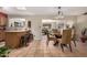 Open dining room featuring a glass table, pendant lighting, and easy access to kitchen at 8229 E Farmdale Dr, Mesa, AZ 85208