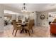 Open dining room featuring a glass table and easy access to living room at 8229 E Farmdale Dr, Mesa, AZ 85208