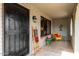 Cozy front porch showcasing seating area, desert accents, and a security door at 8229 E Farmdale Dr, Mesa, AZ 85208