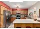 Bright kitchen featuring stainless steel appliances and light wood cabinets at 8229 E Farmdale Dr, Mesa, AZ 85208