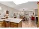 Bright kitchen with light countertops, wood cabinets, and an adjacent dining area at 8229 E Farmdale Dr, Mesa, AZ 85208
