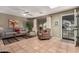 Bright living room with tile floors, stylish furnishings, ceiling fan, and natural light at 8229 E Farmdale Dr, Mesa, AZ 85208