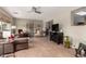 Spacious living room with tile floors, comfortable seating, and view into adjacent living area at 8229 E Farmdale Dr, Mesa, AZ 85208