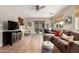 Open living room with tile floors, ceiling fan, and sliding door to the patio at 8229 E Farmdale Dr, Mesa, AZ 85208