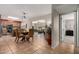 Open floorplan view of kitchen, dining area, and living room with lots of natural light at 8229 E Farmdale Dr, Mesa, AZ 85208