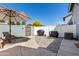 The backyard patio features two grills, an umbrella table with chairs, and a well-kept concrete patio at 860 N Mcqueen Rd # 1213, Chandler, AZ 85225