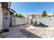 Charming backyard patio features stylish seating, a striped umbrella, and mixed concrete and brick pavers at 860 N Mcqueen Rd # 1213, Chandler, AZ 85225
