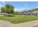 Well-maintained building exterior with lush green lawns, showcasing a welcoming community environment at 860 N Mcqueen Rd # 1213, Chandler, AZ 85225