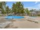 Community pool area with ample seating and well-maintained landscaping for a relaxing and enjoyable experience at 860 N Mcqueen Rd # 1213, Chandler, AZ 85225