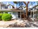 View of condo featuring tiled roof, green landscaping, and covered entrance way at 860 N Mcqueen Rd # 1213, Chandler, AZ 85225