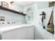 Bright laundry room features modern appliances, floating shelf and natural light at 860 N Mcqueen Rd # 1213, Chandler, AZ 85225