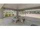 Covered picnic area with stone table and benches, offering a comfortable outdoor gathering space at 860 N Mcqueen Rd # 1213, Chandler, AZ 85225