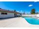 Stunning backyard with sparkling pool, an outdoor lounge area, and a white fence surround at 8602 E Whitton Ave, Scottsdale, AZ 85251