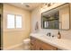 Beautiful bathroom features a framed mirror, decorative lights, and stone countertops at 8602 E Whitton Ave, Scottsdale, AZ 85251