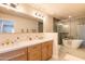 Spa-like bathroom with double vanity, freestanding tub, tiled shower, and modern fixtures at 8602 E Whitton Ave, Scottsdale, AZ 85251