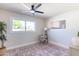 Bright, open bedroom features a ceiling fan and a large window that fills the room with natural light at 8602 E Whitton Ave, Scottsdale, AZ 85251