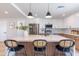 Stylish kitchen featuring an island with seating, modern pendant lights, and wood and white cabinetry at 8602 E Whitton Ave, Scottsdale, AZ 85251
