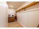Functional walk-in closet with shelving, cabinetry, and a ladder for accessing higher storage at 8602 E Whitton Ave, Scottsdale, AZ 85251