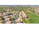 Aerial view of home's community features mature trees, landscaping, sidewalks, and nearby golf course at 8841 S 51St St # 1, Phoenix, AZ 85044