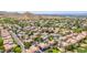 Scenic aerial view of community features desert landscape, golf course, mature trees, and city views at 8841 S 51St St # 1, Phoenix, AZ 85044