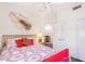 Cozy bedroom with comfortable bed, ceiling fan, natural light, and closet doors at 8841 S 51St St # 1, Phoenix, AZ 85044