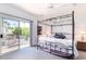 Bright bedroom with a four poster bed, a ceiling fan, and access to a private balcony with great views at 8841 S 51St St # 1, Phoenix, AZ 85044