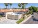 Inviting two-story home with a three-car garage, well-maintained lawn, desert landscaping, and palm trees at 8841 S 51St St # 1, Phoenix, AZ 85044