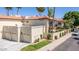 Inviting two-story home with a three-car garage, well-maintained lawn, desert landscaping, and palm trees at 8841 S 51St St # 1, Phoenix, AZ 85044