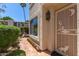 Charming front entrance with a decorative security door, tiled walkway, and lush desert landscaping at 8841 S 51St St # 1, Phoenix, AZ 85044