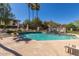 Community pool area featuring lounge chairs, green landscaping, clear skies, and mountain views at 8841 S 51St St # 1, Phoenix, AZ 85044