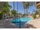 Community pool features blue tile, clear water, ample seating, surrounded by trees and black wrought iron fence at 8841 S 51St St # 1, Phoenix, AZ 85044