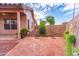 Charming backyard with a covered patio, brick accents, and desert landscaping at 910 W Redondo Dr, Gilbert, AZ 85233