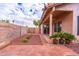 Charming backyard with a covered patio, brick accents, and desert landscaping at 910 W Redondo Dr, Gilbert, AZ 85233