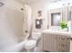 Bright bathroom with white subway tile in shower and a gray vanity with sink at 910 W Redondo Dr, Gilbert, AZ 85233