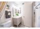 Bright bathroom featuring a single sink vanity, hexagon tile floors, and a decorative mirror at 910 W Redondo Dr, Gilbert, AZ 85233