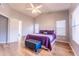 Comfortable bedroom featuring a ceiling fan, wood floors, and a padded bench at 910 W Redondo Dr, Gilbert, AZ 85233