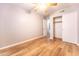 Bedroom showing laminate flooring, gray walls, closet, and a ceiling fan at 910 W Redondo Dr, Gilbert, AZ 85233
